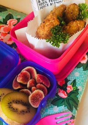 A picture of Crumbed chicken strips with fresh delicate figs and kiwi.