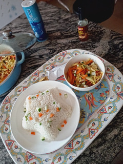 A picture of Assorted sauteed veggies with white rice.