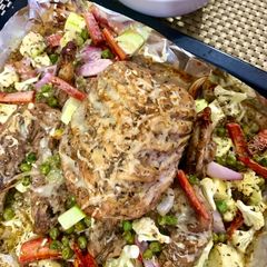 A picture of Buttermilk dipped Baked chicken with baked veggies.