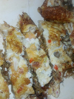A picture of Folded Dambun nama(Spiced, Crushed meat) with egg.