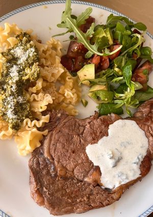 A picture of Steak with Pasta and Salad.