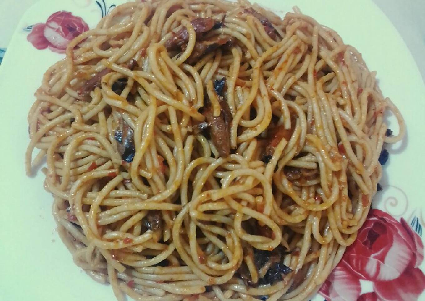 Spaghetti jollof & torn titus smoked fished