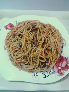 A picture of Spaghetti jollof & torn titus smoked fished.
