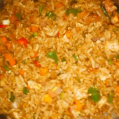A picture of Vegetable stir fried rice with sausages.