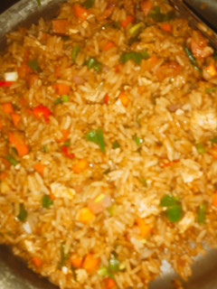 A picture of Vegetable stir fried rice with sausages.