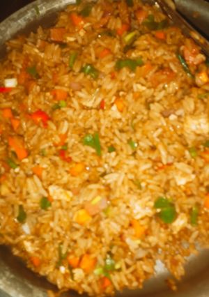 A picture of Vegetable stir fried rice with sausages.
