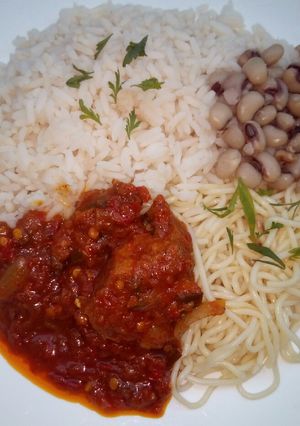 A picture of Rice,beans,spaghetti and stew.