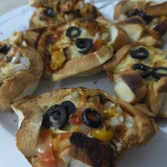 A picture of Bread pizza cups ready in 10 minutes.