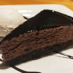 A picture of Chocolate Fudge Brownie with Vanilla Ice cream and chocolate sauce.