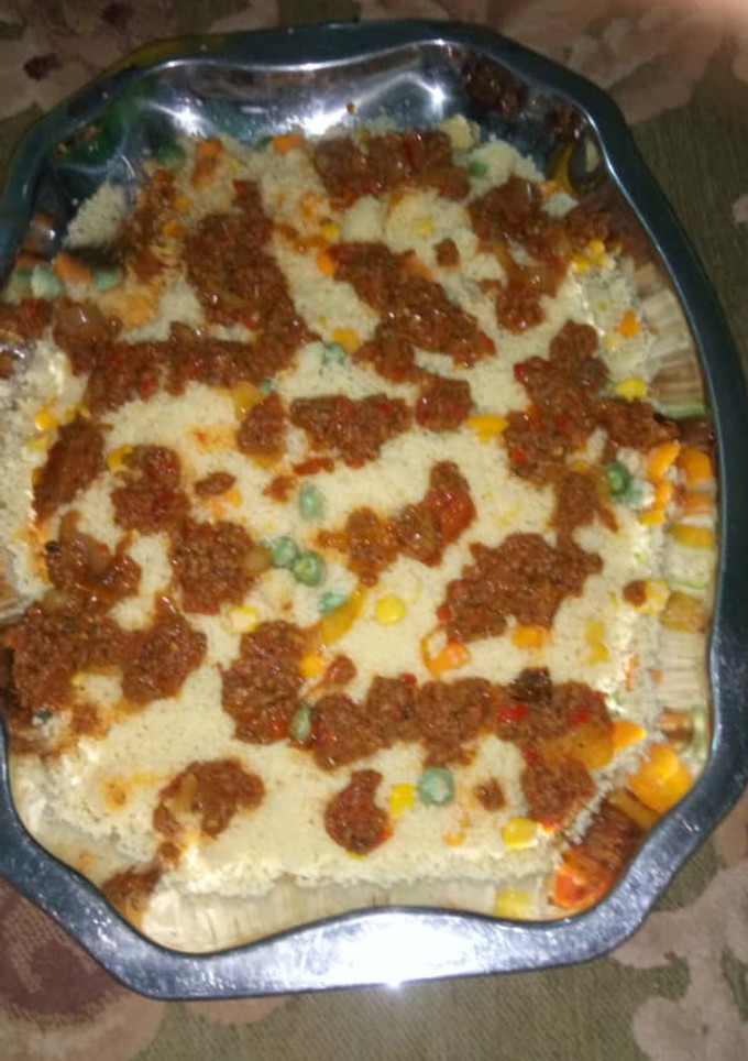 A picture of Kus kus with souce.