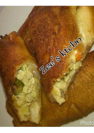 A picture of Bread roll and scramble egg filling.