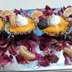 A picture of Orange custard with chocolate cups.