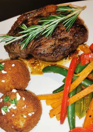 A picture of Rosemary Beef Picanah, Mash potato balls with Veggie stir fry.
