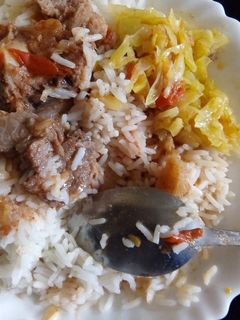 A picture of Rice beef and fried cabbage.