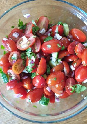 A picture of Baby plum tomato, cucumber, onion, chilli & coriander salad.