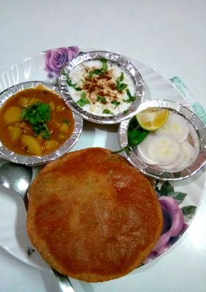 A picture of Sabji, kachori and boondi raita.
