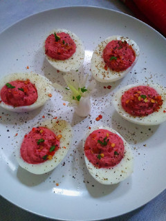 A picture of Deviled Eggs with Beetroot Hummus.