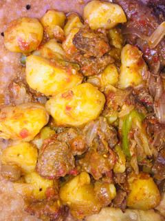 A picture of Potatoes and beef sauce.