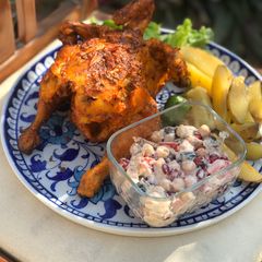 A picture of Grilled tandoori chicken with grilled potatoes.