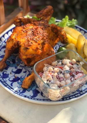 A picture of Grilled tandoori chicken with grilled potatoes.