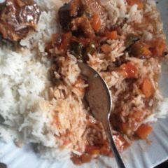 A picture of Beef Stew Served with Rice.