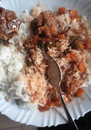 A picture of Beef Stew Served with Rice.