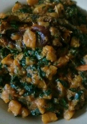 A picture of Unripe plantain with vegetable and dry fish.