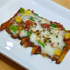 A picture of French fries pizza.