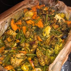 A picture of Chicken with vegetables in the oven.