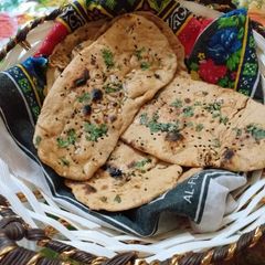 A picture of Wheat flour naan with deggi korma.