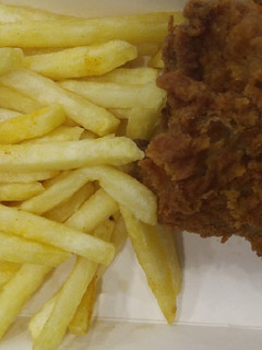 A picture of French fries with Fried Chicken.