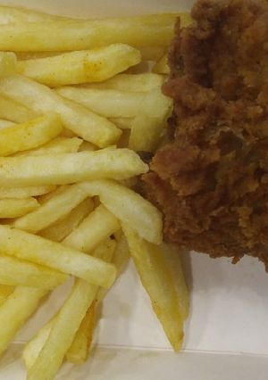 A picture of French fries with Fried Chicken.