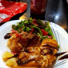 A picture of Fish steak with veggies.