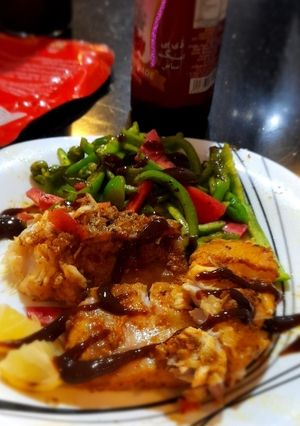 A picture of Fish steak with veggies.