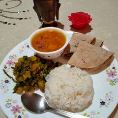 A picture of Radish leaves sabzi, tomato arhar dal,rice & roti.