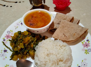 A picture of Radish leaves sabzi, tomato arhar dal,rice & roti.