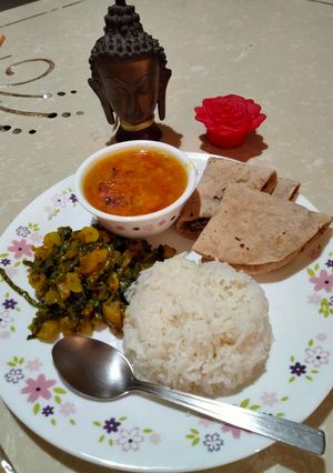 A picture of Radish leaves sabzi, tomato arhar dal,rice & roti.