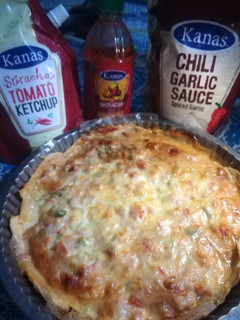 A picture of Baked Paratha chicken in red sauces.