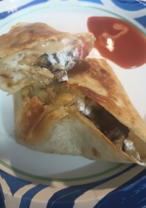 A picture of Leftovers: Lamb and Bean Burrito and a Puddle of Hot Sauce.