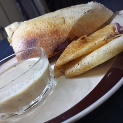 A picture of Dosa with coconut chutney.