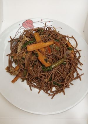 A picture of Brown veggies spaghetti.