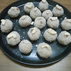 A picture of Coconut laddu with dry fruits.