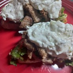 A picture of Pork Gyros with Tzaziki.