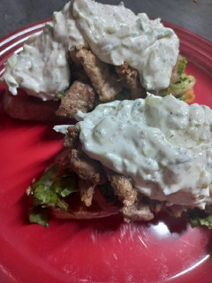 A picture of Pork Gyros with Tzaziki.