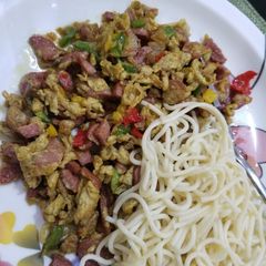 A picture of Spaghetti and sausage sauce.