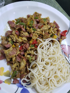 A picture of Spaghetti and sausage sauce.