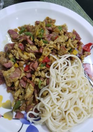 A picture of Spaghetti and sausage sauce.