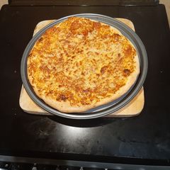 A picture of Homemade traditional pizza.