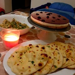 A picture of Tawa Naan with paneer handi and blueberry cheese cake.
