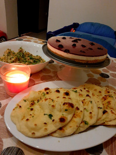 A picture of Tawa Naan with paneer handi and blueberry cheese cake.